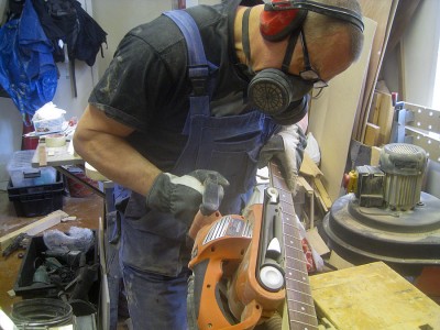 With the fretboard in place I continued to shape the neck - with the belt sander.