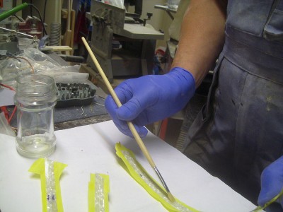 Glueing strips of celluloid binding together.