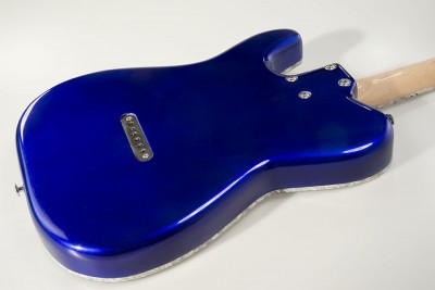 The back. The steel bar string retainer gives a good sustain. So no ferrules here.
