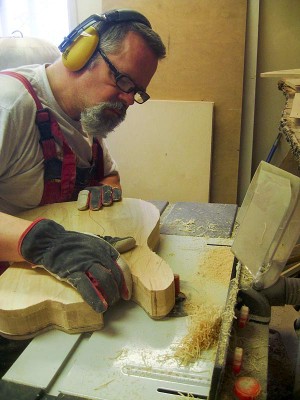 Trimming the body edge flush with the template using a table router.