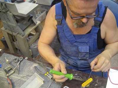 Soldering lead wires to the coil.