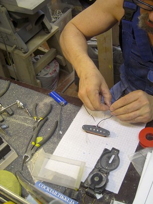 Attaching neodymium magnets to polepieces. I check the polarity with a good compass several times to rule out any of the polepieces going out of phase.