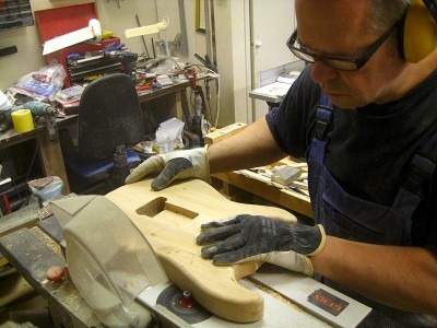 Rounding off the body edges with a table router.