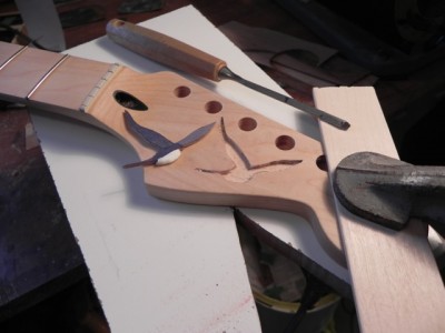 Routing out the design. The bird was made from different species of wood I had laying around the shop, as well as a piece of shell for the belly.