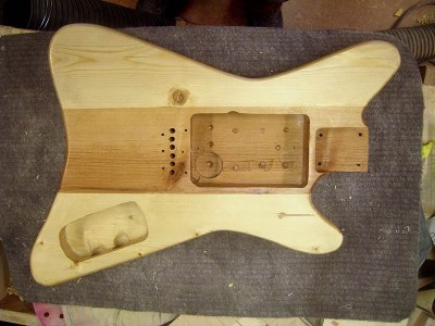 The body has a swimming pool type pickup cavity to accommodate any type of pickup. I modified a Strat pickguard to fit the guitar and made a couple new ones of 2 mm PVC sheet. The control cavity cover is also PVC.