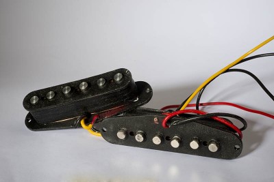 These are my Texas Blues style high output Strat pickups &quot;Las Tejanitas&quot;. You can see the neodymium button magnets at the bottom of one of the pickups. They make the pickup taller than AlNiCo rods would but no more than a ceramic bar magnet does. I make my Tejanita coils a bit taller than standard on purpose to room more windings.