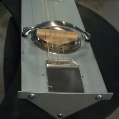 The assembled resonator is held together by a screw which also &quot;loads the cone&quot;. The tailpiece was bent from a scrap piece of stainless steel. The handrest is a large drawer pull.